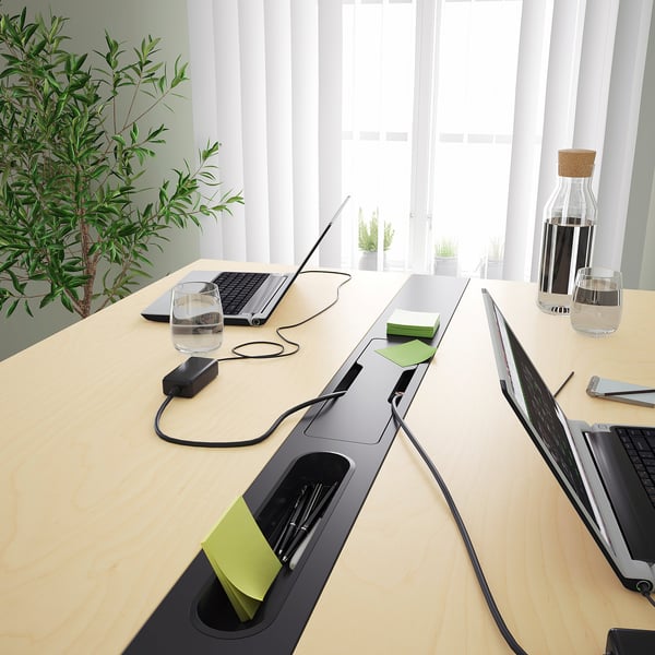 Conference table with cable management, footrest, power outlet and hooks.