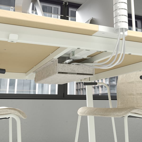 Modern conference table with built-in cable management and storage hooks.