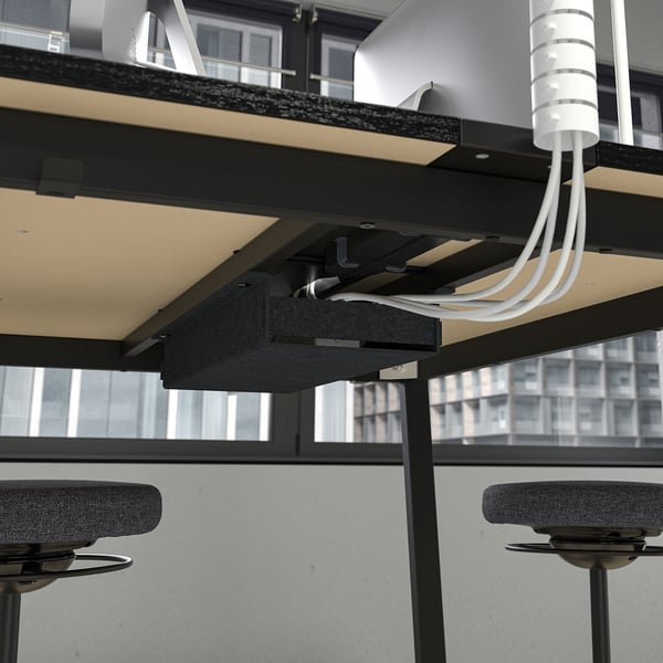 Image shows MITTZON high tables cable management, with visible white cables organised under the tabletop.