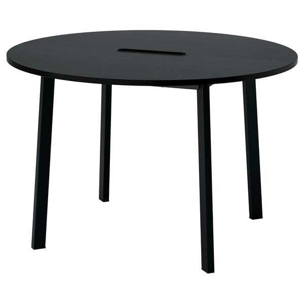 Black round conference table, four metal legs, sleek design.