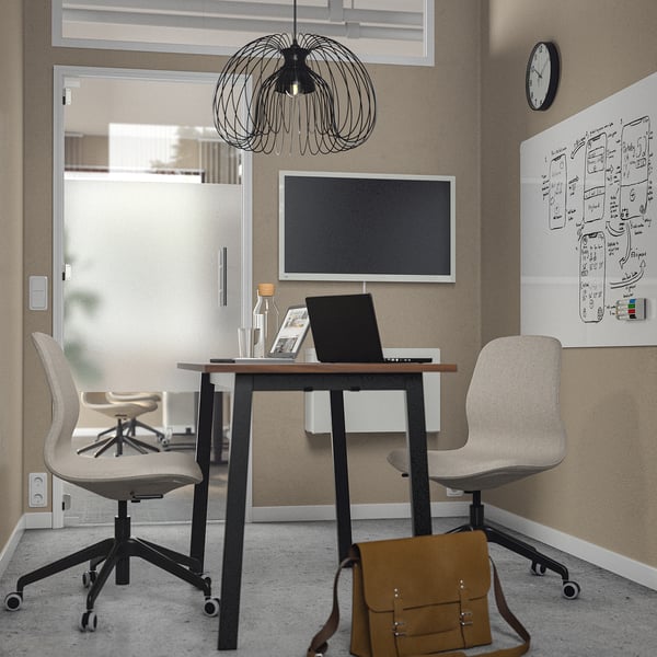 Office with MITTZON table, chairs, whiteboard, and pendant lamp. Brown bag on floor.