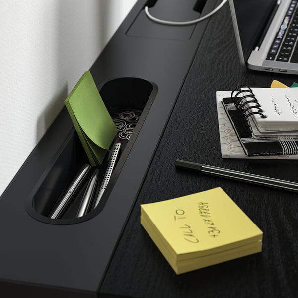 Desk organiser with pen, sticky notes, and notebook compartments for efficient workspace.