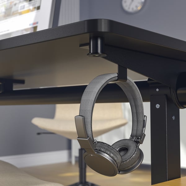 Black foldable meeting table with headphone hook.