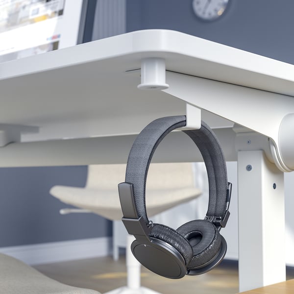 Foldable conference table with hooks for bags or headphones.