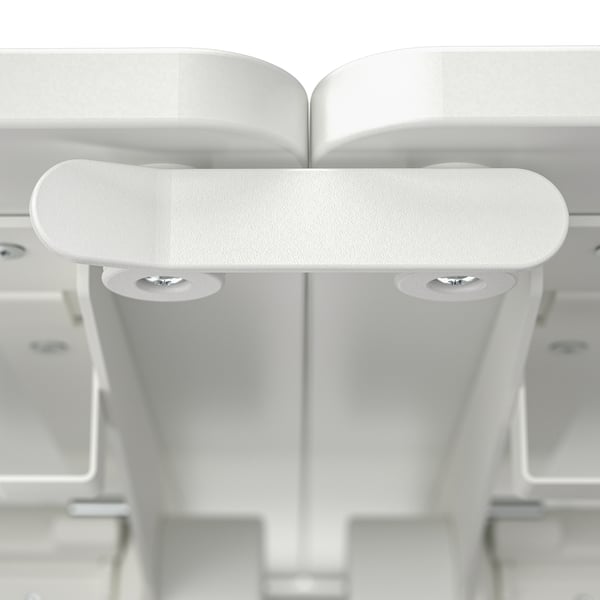 Multiple white foldable tables in a clean, organised storage area, showing robust construction and sturdy connectors.