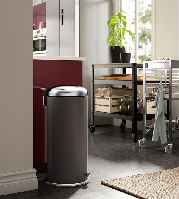 Modern kitchen with gray MJÖSA bin, plant cart.