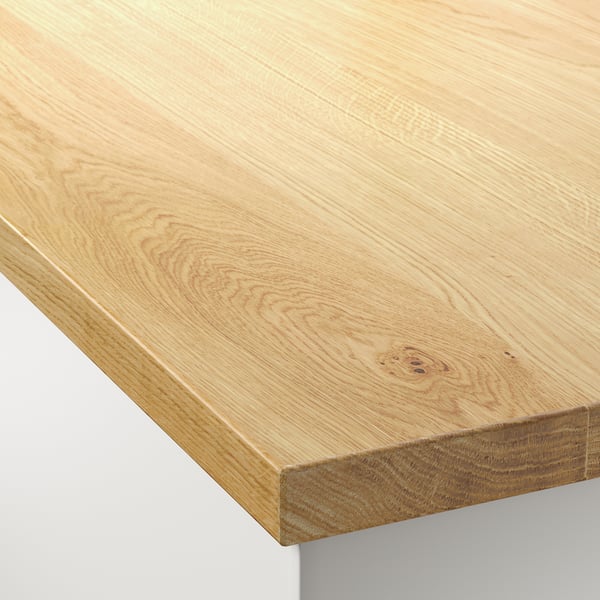 Close-up of a sleek, light-colored wooden worktop with smooth, even grain and rounded edges, showcasing the high-quality finish and craftsmanship.