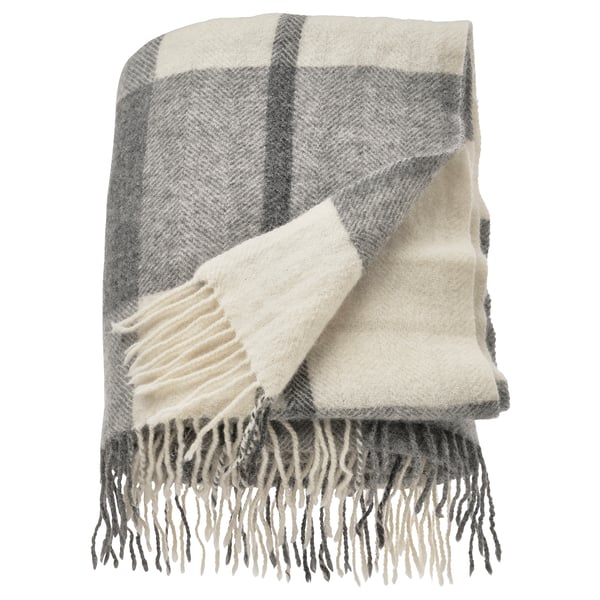 A MYRULL wool throw blanket in light grey and white with a chequered pattern, featuring fringed edges.