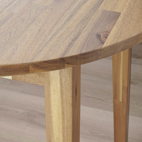 Close-up of acacia wood table edge, smooth finish, natural grain design.