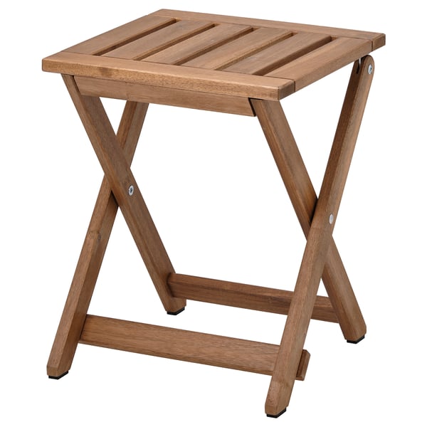 This image shows an ikea NÄMMARÖ wooden stool, brown, square-shaped, foldable with a simple, sturdy design.