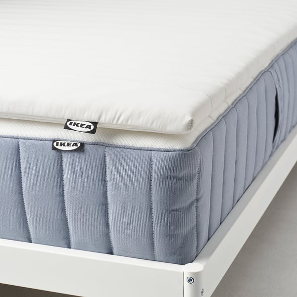 Ikea mattress pad, double-sided & washable, adds softness and comfort.