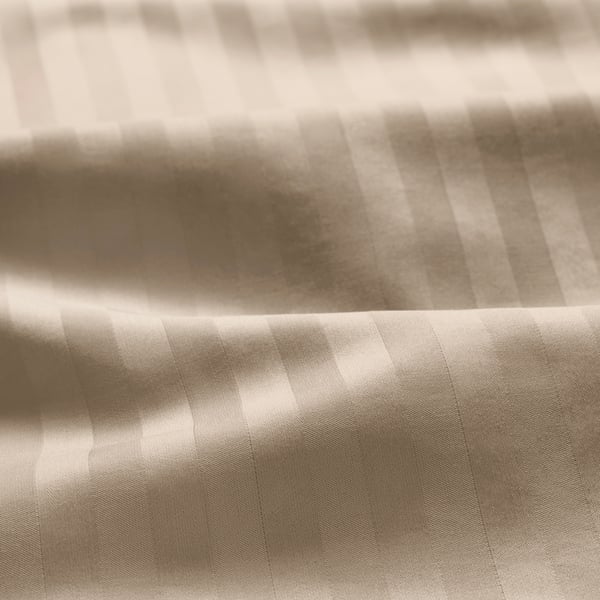 Close-up of luxurious duvet cover showcasing subtle stripes & smooth sateen texture.