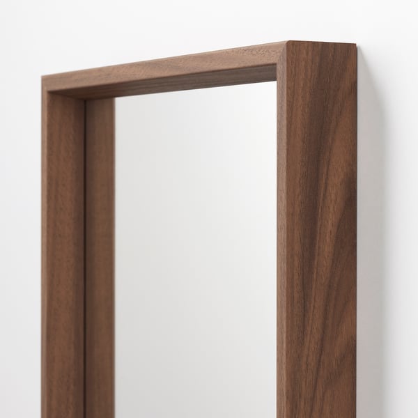 Wooden-framed mirror with dark finish. Quality craftsmanship; smooth edges and even surface.