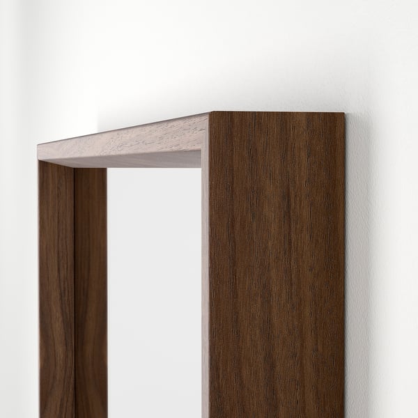 Brown-framed rectangular mirror against a white wall, showing high-quality finish and sleek design for modern decor.