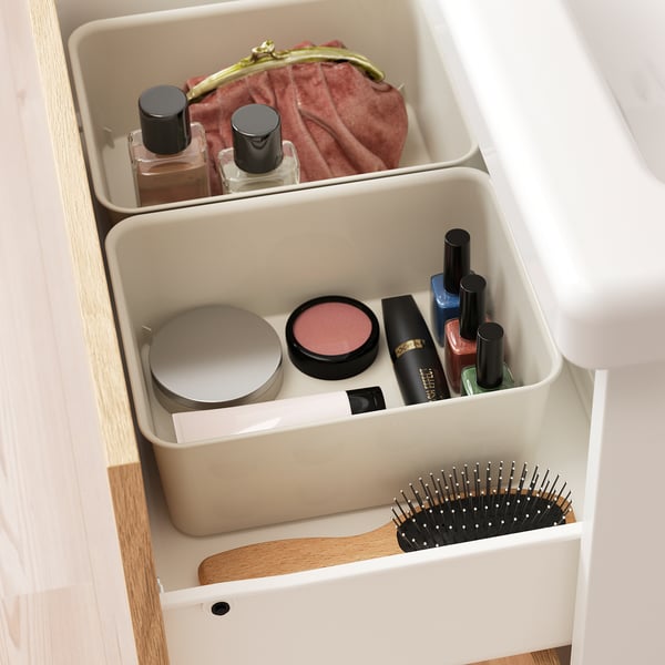Tall plastic organiser drawer with makeup items and brush. Maximises space and keeps things tidy.