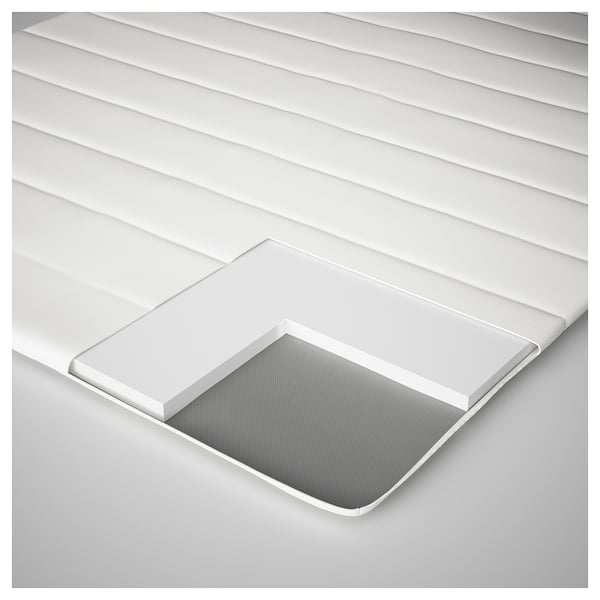 A white, multi-layered mattress cover with a zippered opening.