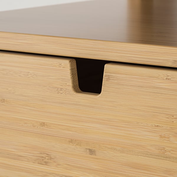 Close-up of bamboo drawer handle, smooth finish, clear lacquer, quality craftsmanship.