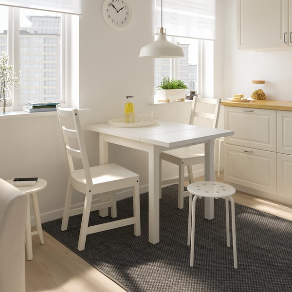 Small white NORDVIKEN dining set with extendable table and chairs in cosy kitchen.