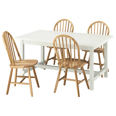 White extendable dining table with four light brown wooden chairs, featuring simple and classic designs.