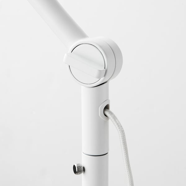 Close-up of stylish lamp joint, sleek white finish, adjustable design, modern aesthetic.