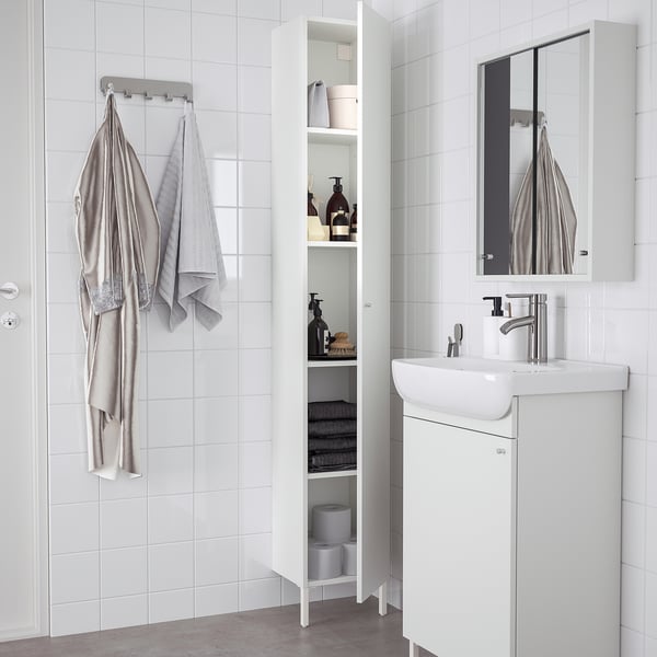Modern white NYSJÖN bathroom cabinet with shelves for towels and toiletries.