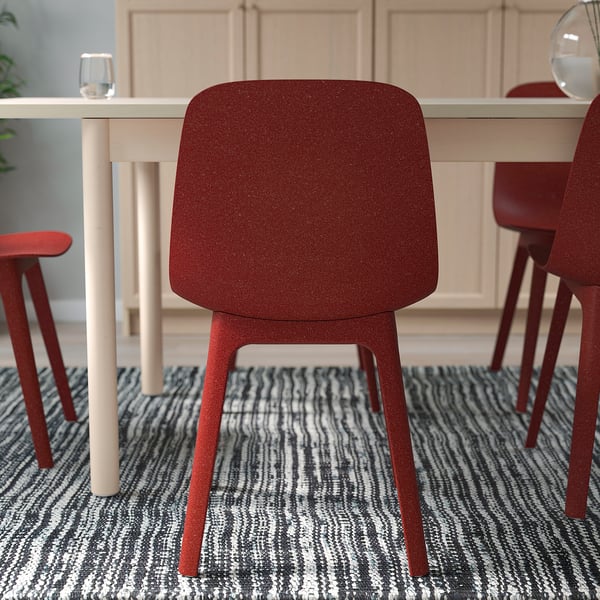 Red chair with wooden legs and backrest, assembled easily for indoor use.