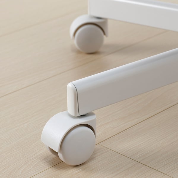 Close-up of modern, high-quality chairs swivel castors on wooden floor. Shows robust design and smooth wheels.