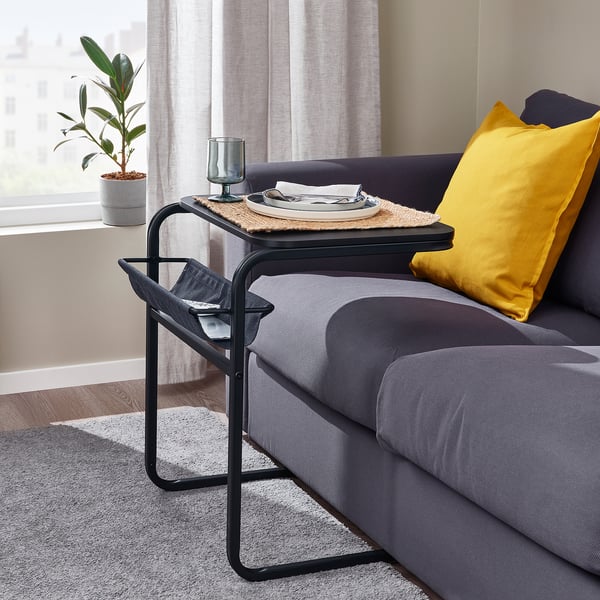 Grey olserod sofa table with yellow pillow, dinnerware, and multipurpose design.