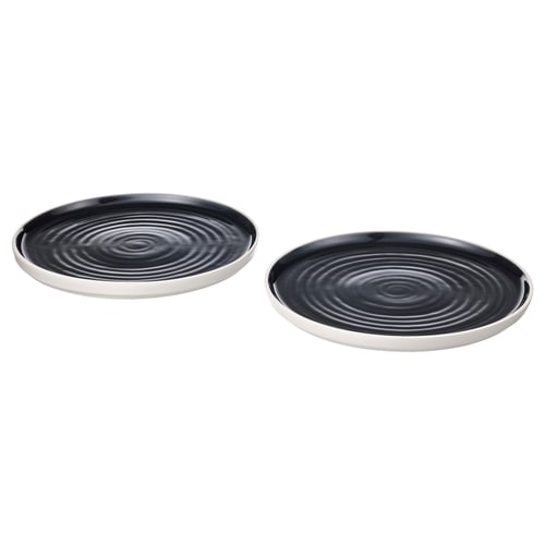 Two round black ceramic plates with concentric circle patterns and shiny edges.