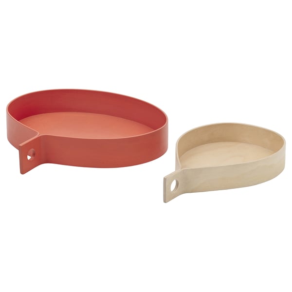 A pair of round, red and natural wood trays with handles, inspired by swedish folk art.