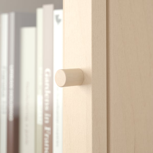 Close-up of modern wooden door handle on light wood surface.