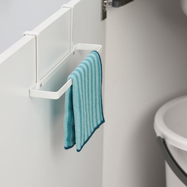 A white over-door rack holds a blue striped towel on a kitchen door.