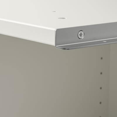 Close-up of a modern, quality white cabinet corner with a sleek, horizontal handle and adjustable feet.