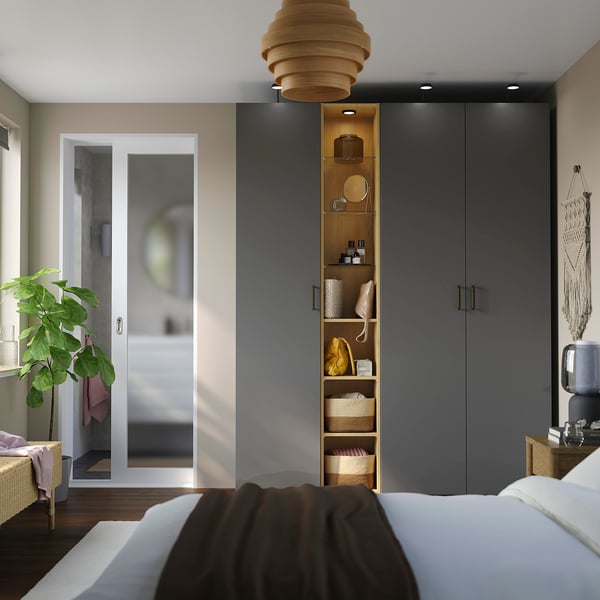 Bedroom with PAX wardrobe, maximising door space. Shelves, pendant light, wicker chair, macramé, bed with linens.