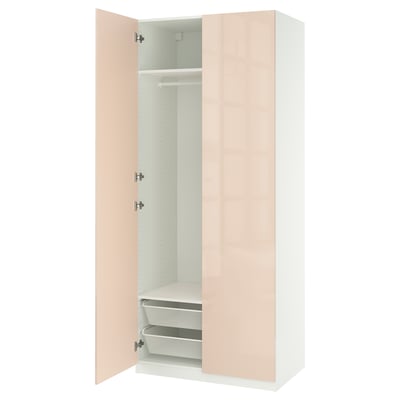 An open PAX wardrobe in light pink with two compartments and mesh drawers.