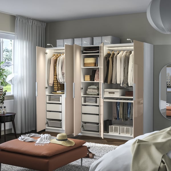 Modern bedroom with PAX wardrobe, organised shelves, drawers, and clothes. Integrated lighting, spacious.