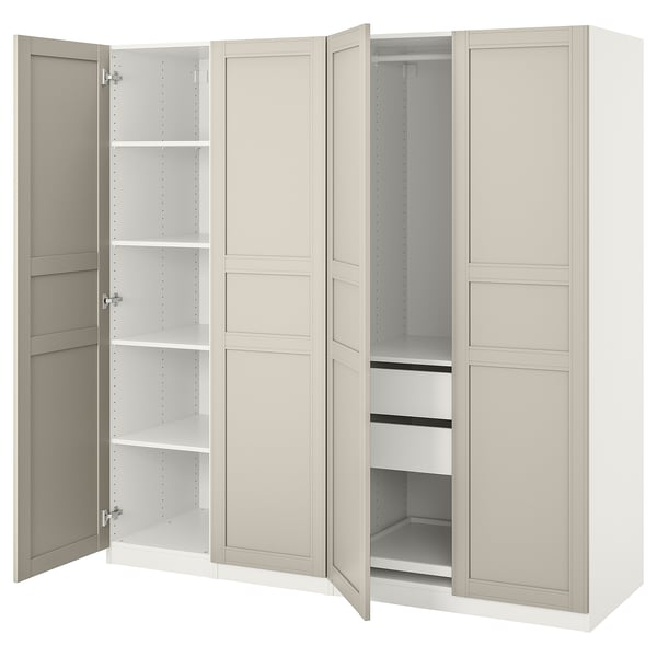 A white ikea PAX wardrobe with open doors, revealing adjustable shelves and compartments. The design is sleek and minimalist.