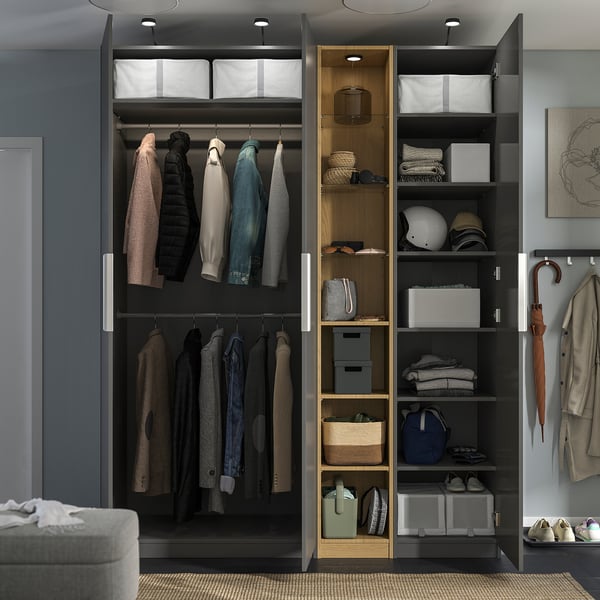 Modern wardrobe with hanging clothes, shelves, storage boxes, and lighting, organised for easy access.