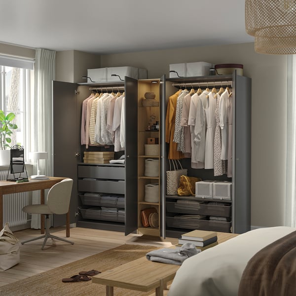 Modern bedroom with open wardrobe, neatly organised clothes.