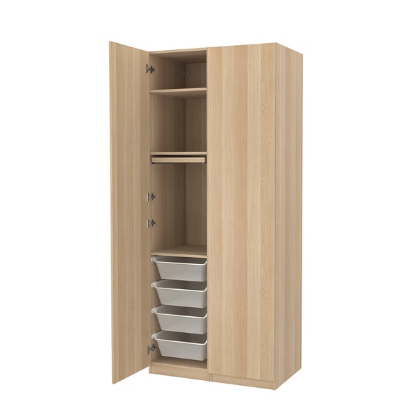 An open wooden PAX wardrobe with shelves and mesh baskets.