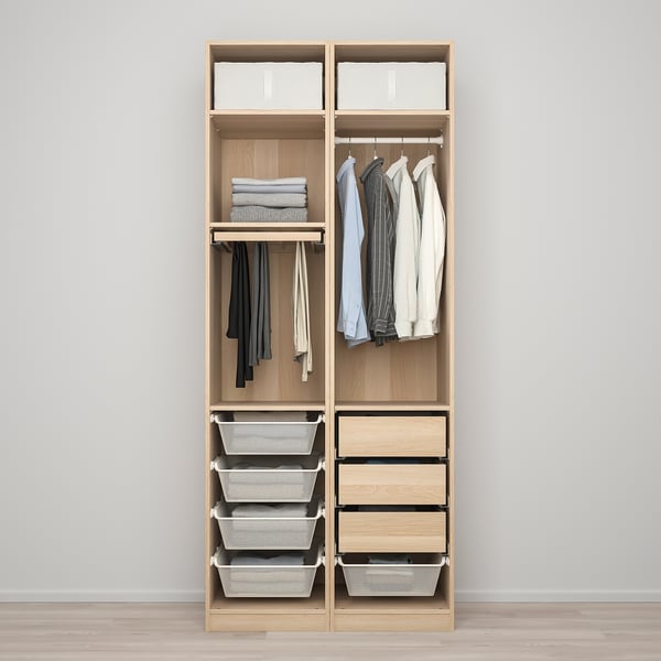 Wooden closet with hanging shirts, folded clothes, and storage baskets.
