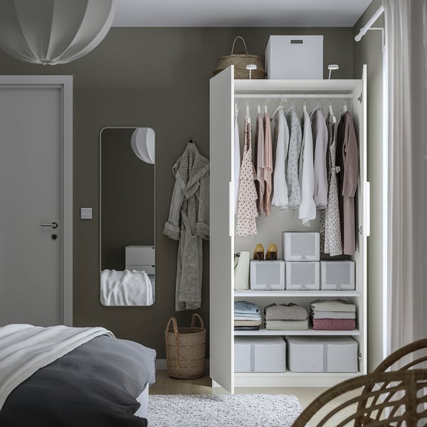 Modern bedroom with PAX wardrobe showing organised clothes and storage.