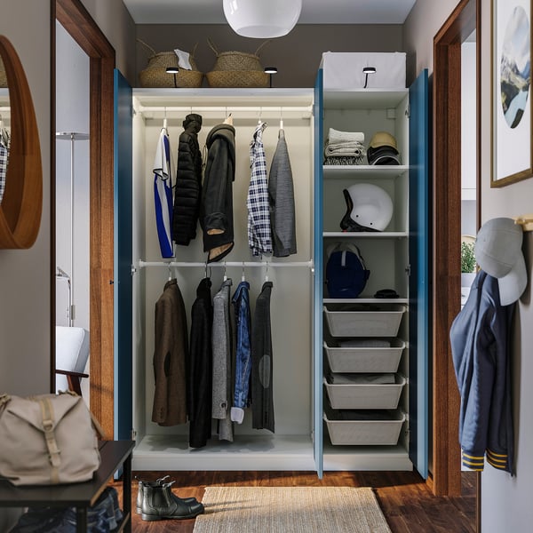 Open wardrobe displaying clothes hangers, baskets, and shelves, showcasing organised storage solutions.