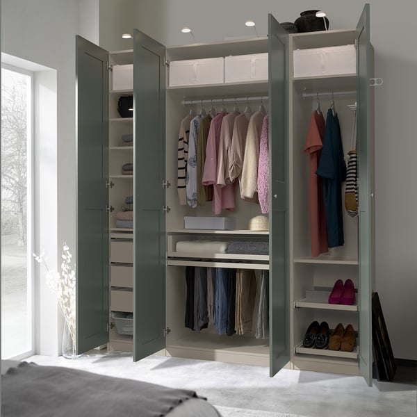 Open green PAX wardrobe showing clothes, shelves, and storage.
