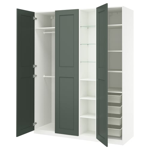 An open PAX wardrobe in green, featuring shelves and drawers, offering organised storage space.