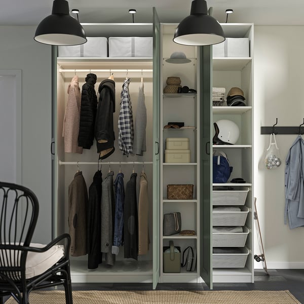 Organised wardrobe with hanging clothes, shelves, baskets, and drawers. Interior lighting and adjustable feet for stability.