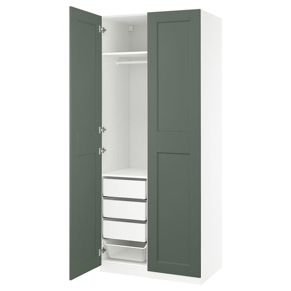 A PAX wardrobe in green with shelves and drawers, perfect for storage in a space-saving design.