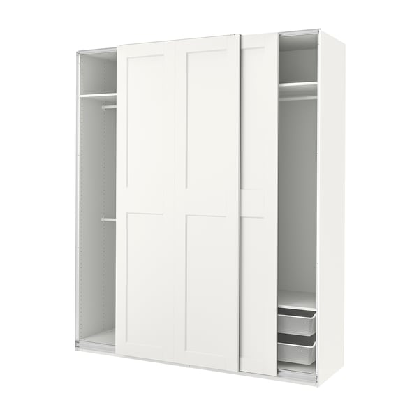 A white PAX wardrobe with sliding doors, showcasing storage shelves and mesh baskets.