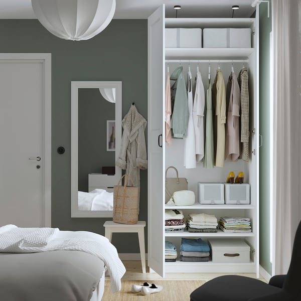 Modern bedroom wardrobe, neatly organising clothes, bags, and folded garments.