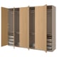 A light brown PAX wardrobe with multiple compartments and shelves for organised storage. It drawers and a hanging section.